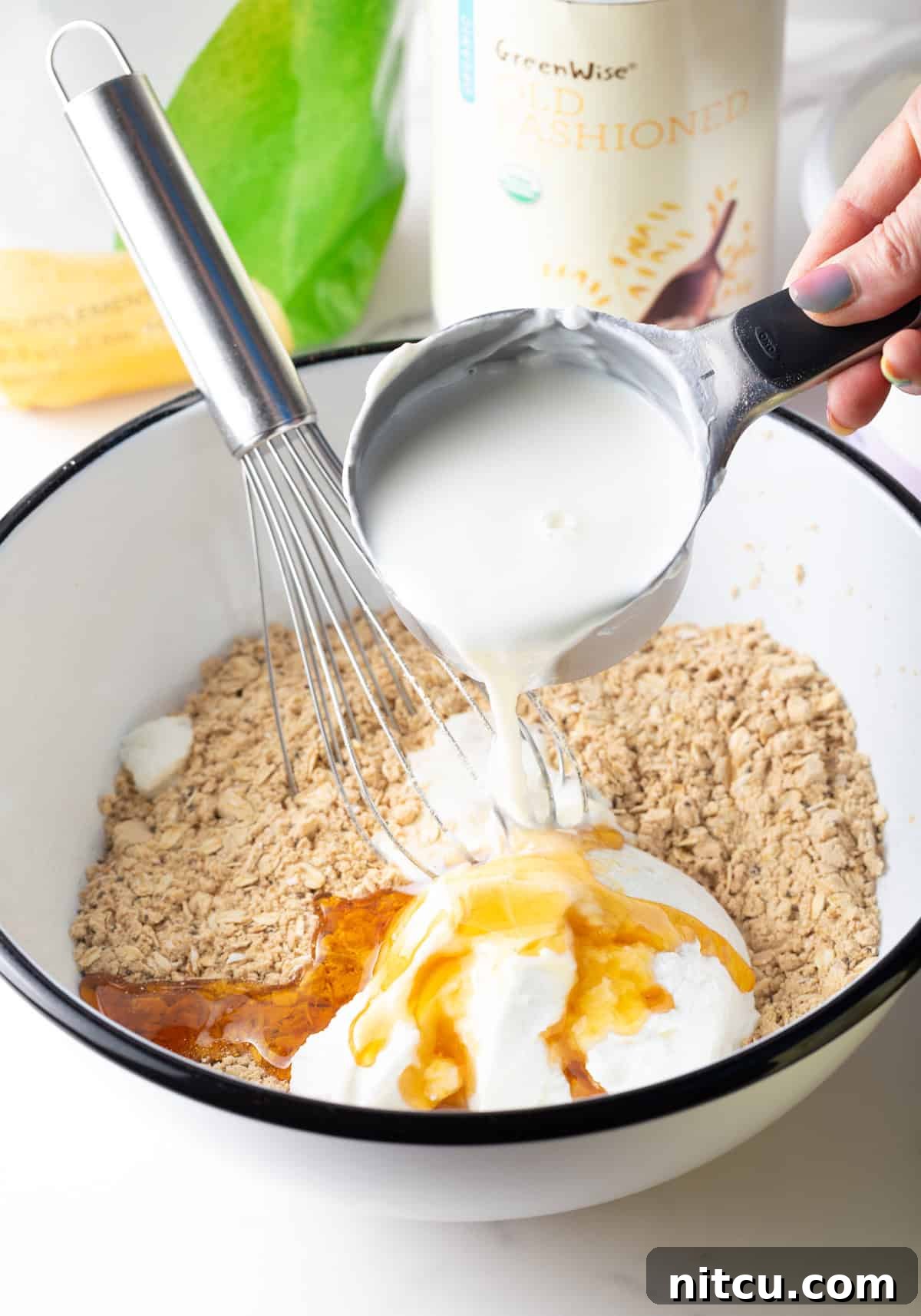 Protein Packed Next-Day Oats 7 Milk being poured over the ingredients for high protein overnight oats recipe.