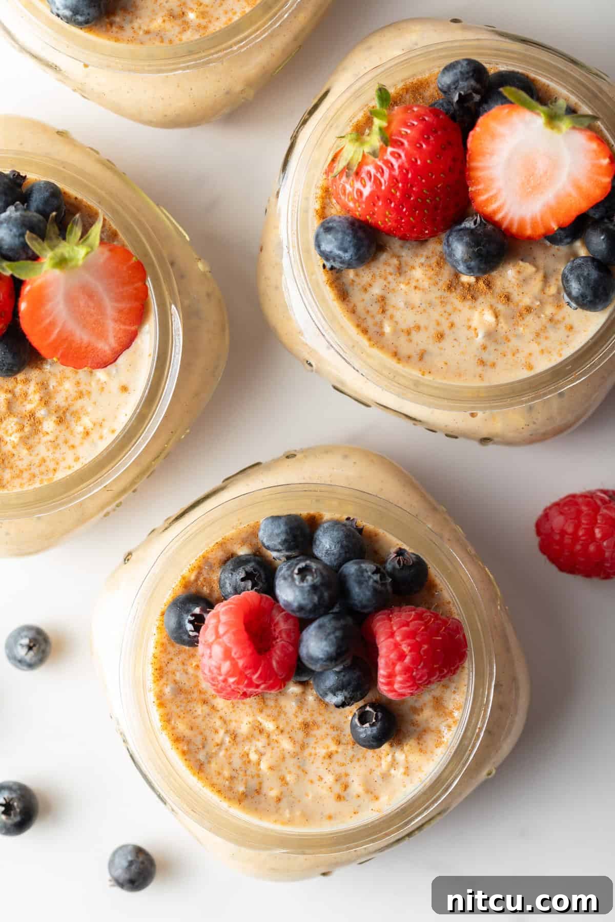 Protein Packed Next-Day Oats 9 easy overnight oatmeal in small jars with berries