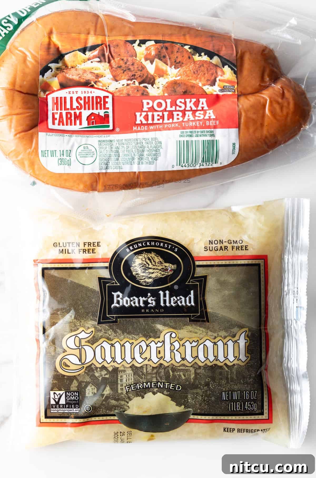 Top down view of ingredients: A package of Hillshire Farms smoked kielbasa sausage and package of Boar's Head sauerkraut