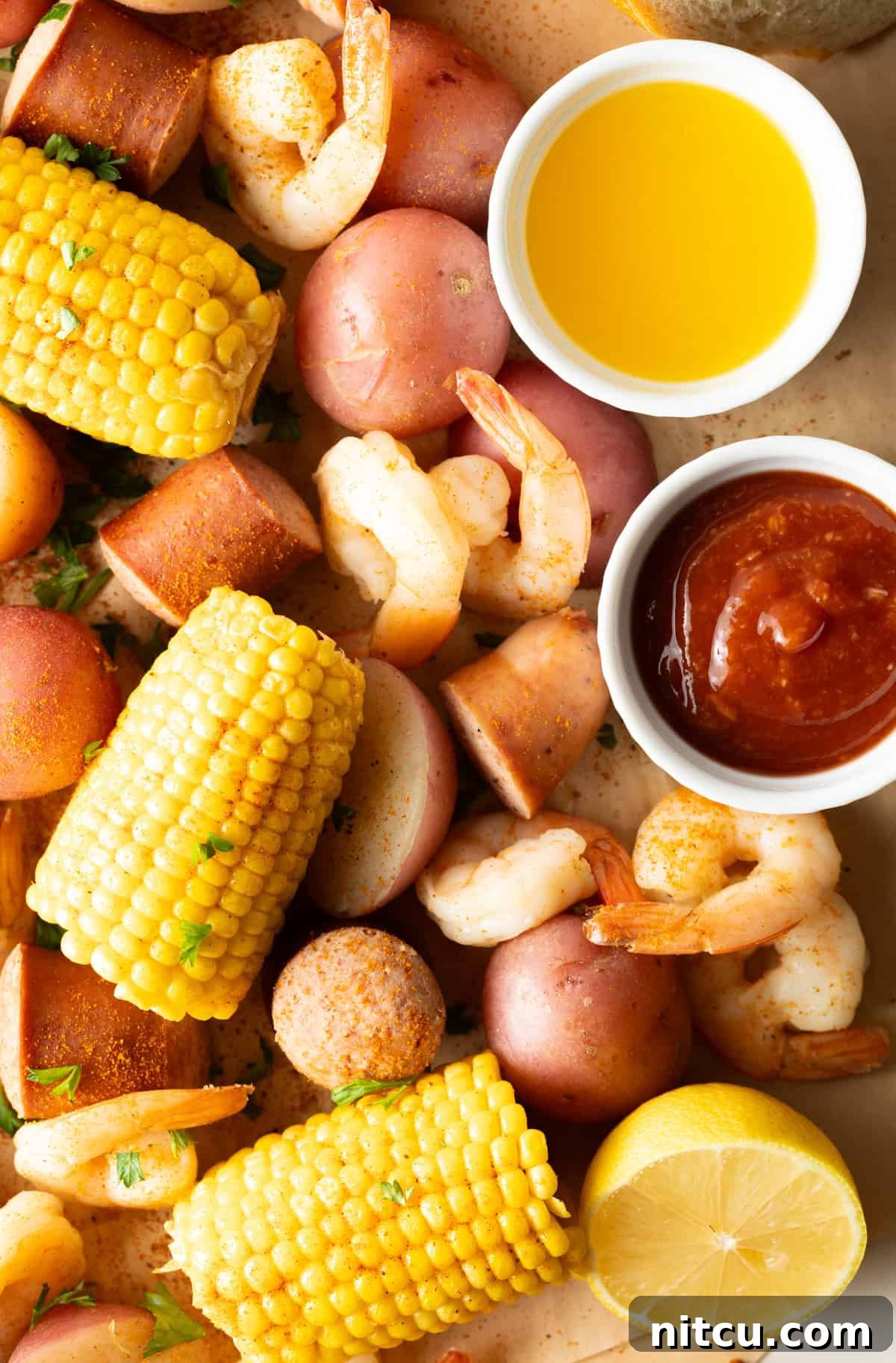 Coastal Bounty Boil 11 A beautifully presented Low Country Boil, with the vibrant colors of shrimp, corn, potatoes, and sausage spilling abundantly onto a serving surface, ready for a gathering.