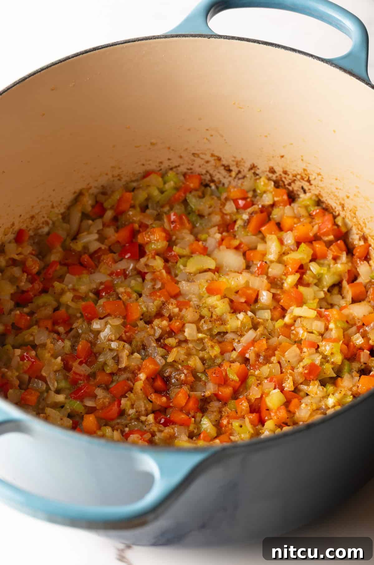 Big Easy Mac and Cheese 6 Vegetables being sautéed in a pot for the Cajun macaroni and cheese recipe.