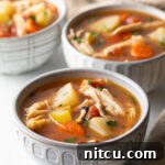 Soul-Satisfying Slow Cooker Chicken Stew 14 3 small white bowls of chicken stew with potatoes, carrots, and celery in a tomato broth.