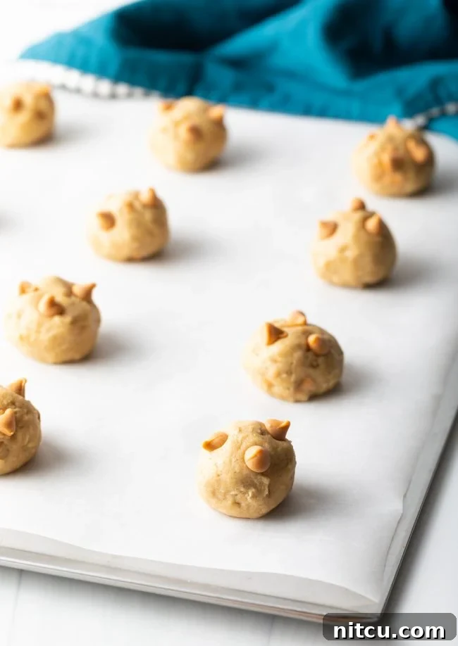 Scooped butterscotch cookie dough balls on a baking sheet, ready to go into the oven.