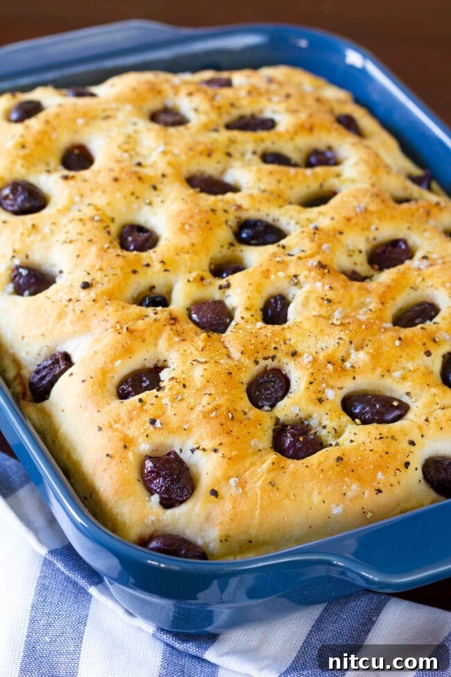 Golden Herb & Olive Focaccia 5 Blue baking dish with tender olive and garlic focaccia bread.