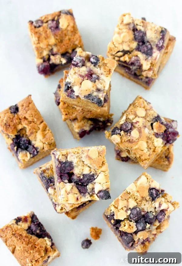 Multiple delicious cut out pieces of Blueberry White Chocolate Blondies, ready for serving.
