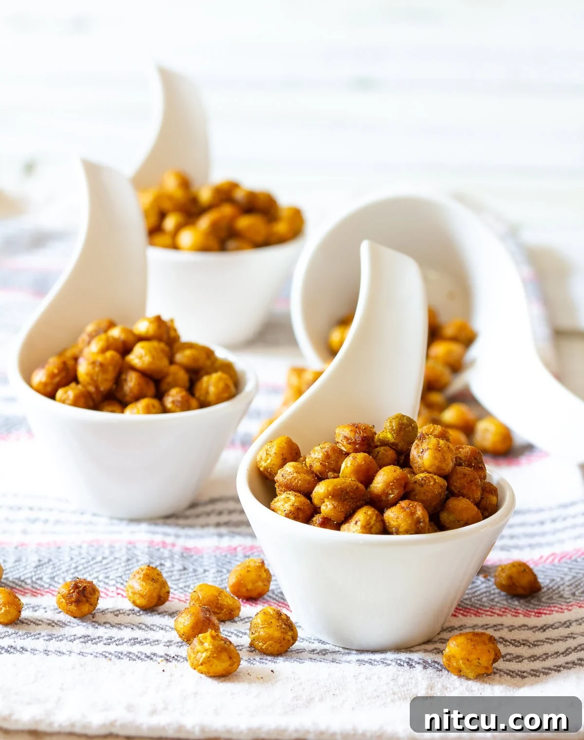 Spicy-Roasted-Chickpeas Spicy Roasted Chickpeas Recipe - a bold and crunchy snack that is waistline-friendly, vegan, and healthy.