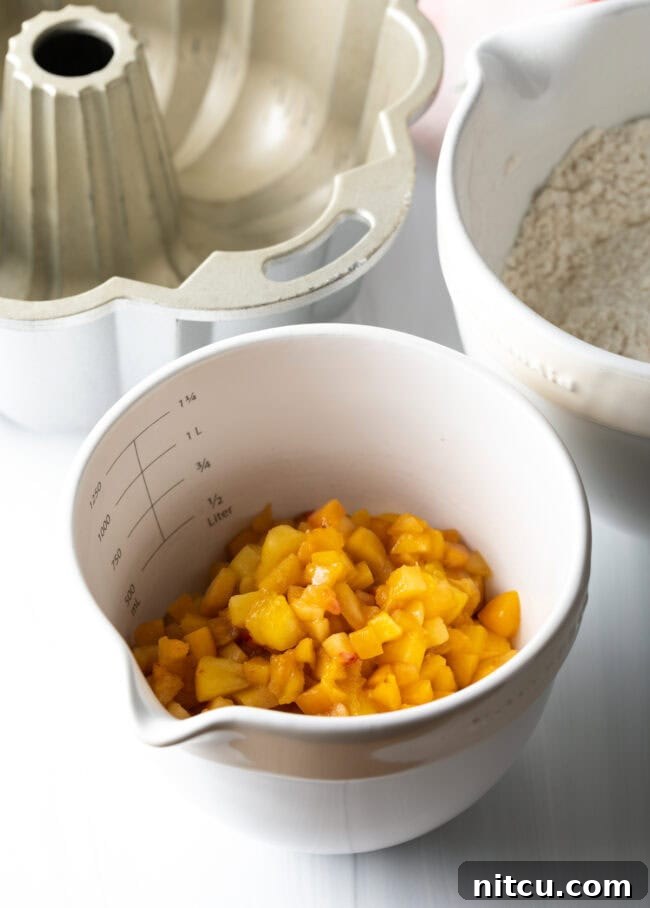 Luscious Peach Bundt Cake 4 A bowl of fresh, ripe peaches, perfectly diced for the cake recipe.