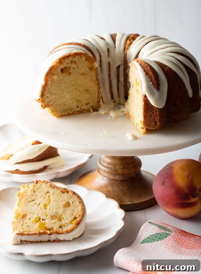 Luscious Peach Bundt Cake 8 Individual slices of peach bundt cake served on white plates, garnished slightly.