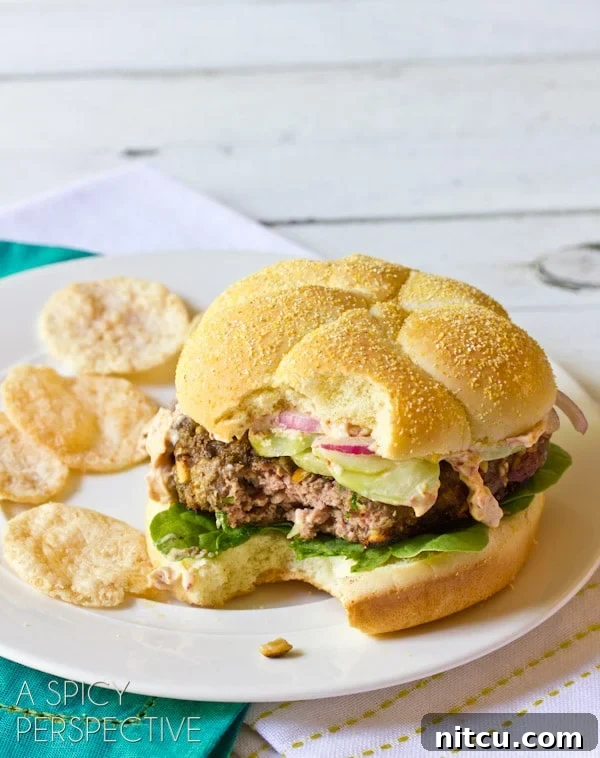 Signature Mediterranean Burger 6 A close-up shot of two easy-to-make Mediterranean burgers, showcasing their fresh ingredients and appealing presentation.