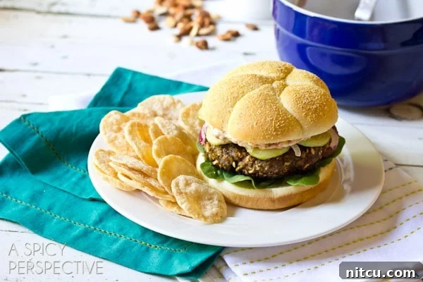 Signature Mediterranean Burger 8 A plated Mediterranean burger served with a side of crispy chips, ready to be enjoyed.