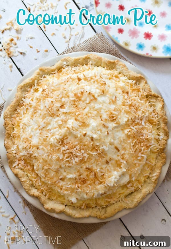 Coconut Cream Pie Coconut Cream Pie - A Coconut Pie Recipe with Cream of Coconut - overhead shot of whole pie on white wooden table