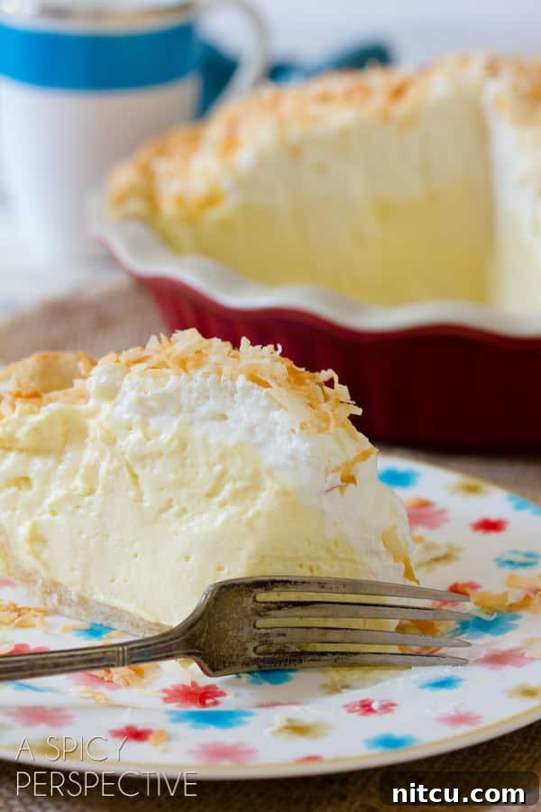 Creamy Coconut Pie Perfection Coconut Cream Pie on plate with fork cutting through thick creamy layers