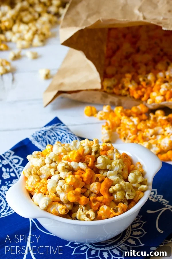 Easy #Copycat Garretts Popcorn AKA "Chicago Mix Popcorn" #caramel #popcorn #cheese #fall #holidays #party #ediblegifts White bowl filled with a mixture of caramel and cheddar popcorn.
