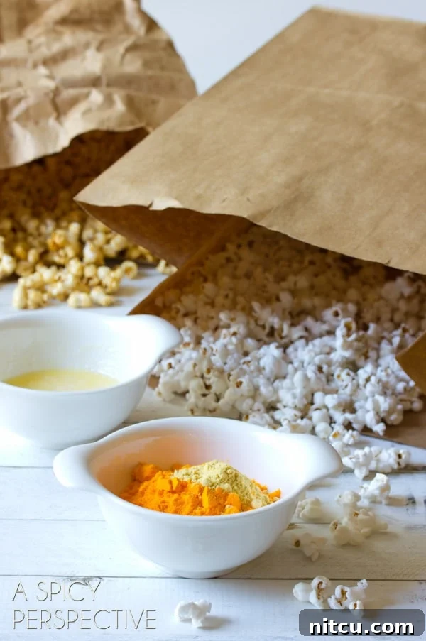 Mastering Garretts Famous Popcorn 4 Two bags of popcorn behind a bowl of melted butter and cheese powder.