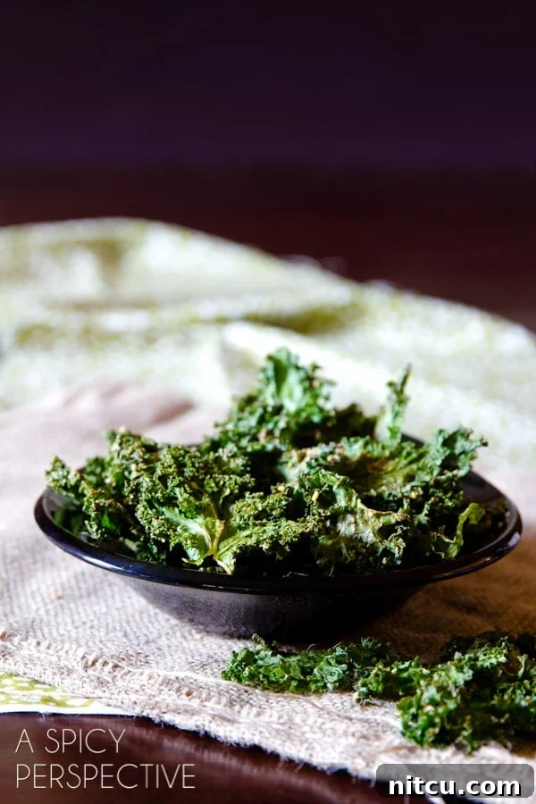 Effortless Crispy Kale Chips 4 Baked kale chips in a small bowl.