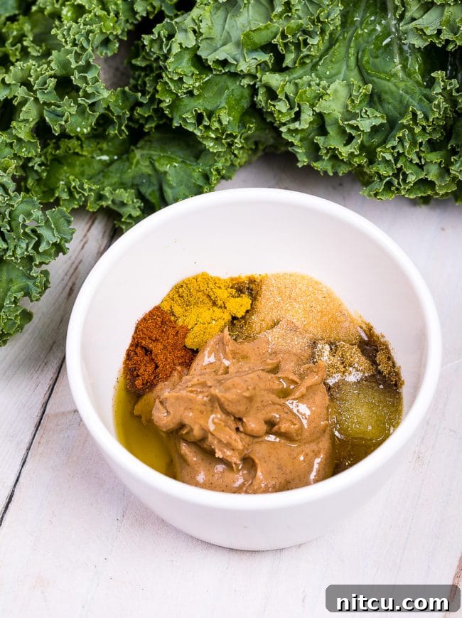Effortless Crispy Kale Chips 6 Spices and almond butter in a bowl.
