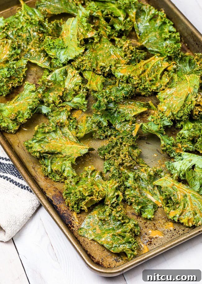 Effortless Crispy Kale Chips 9 Coated kale chips ready to bake.