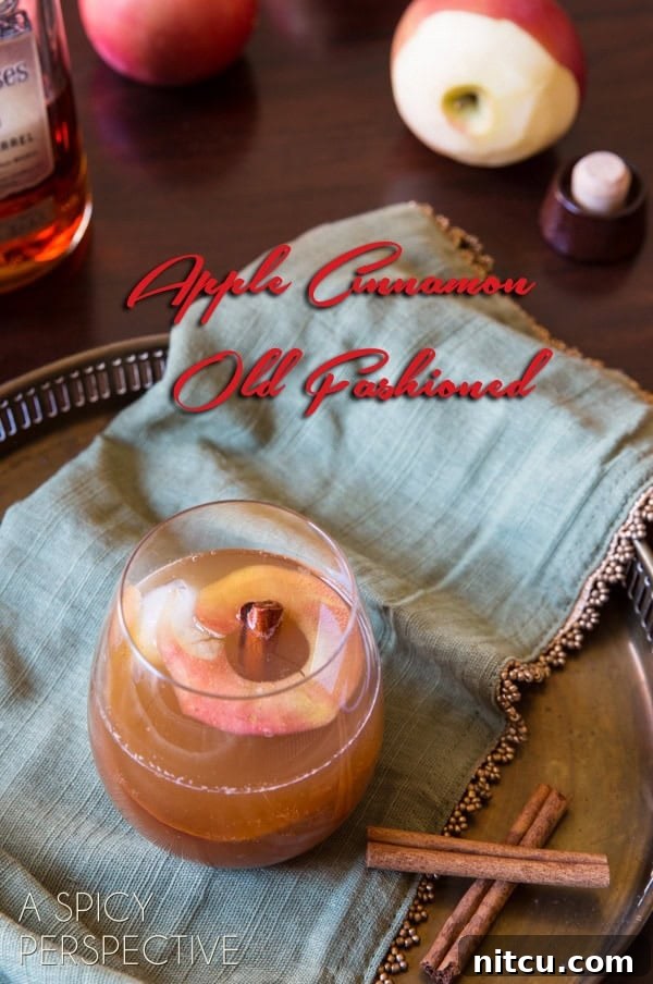 Harvest Apple Old Fashioned 2 Cocktail with cinnamon sticks next to it and text saying 'apple cinnamon old fashioned'.