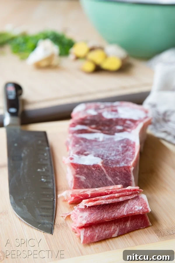 Sizzling Korean BBQ Delights 5 Slicing steak into thin slices on a cutting board with a chef's knife.