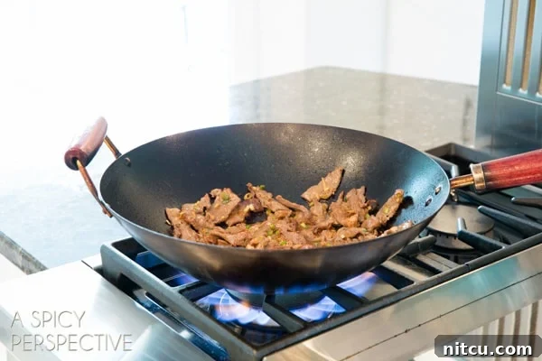 Sizzling Korean BBQ Delights 7 Korean beef bulgogi cooking in a black wok.