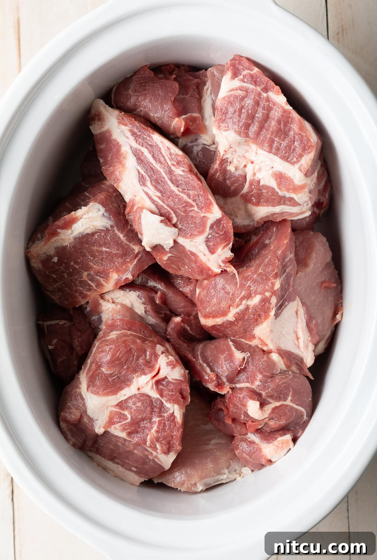 Crispy Pork Carnitas Made Easy 3 Large chunks of raw pork butt roast seasoned and ready for the slow cooker.
