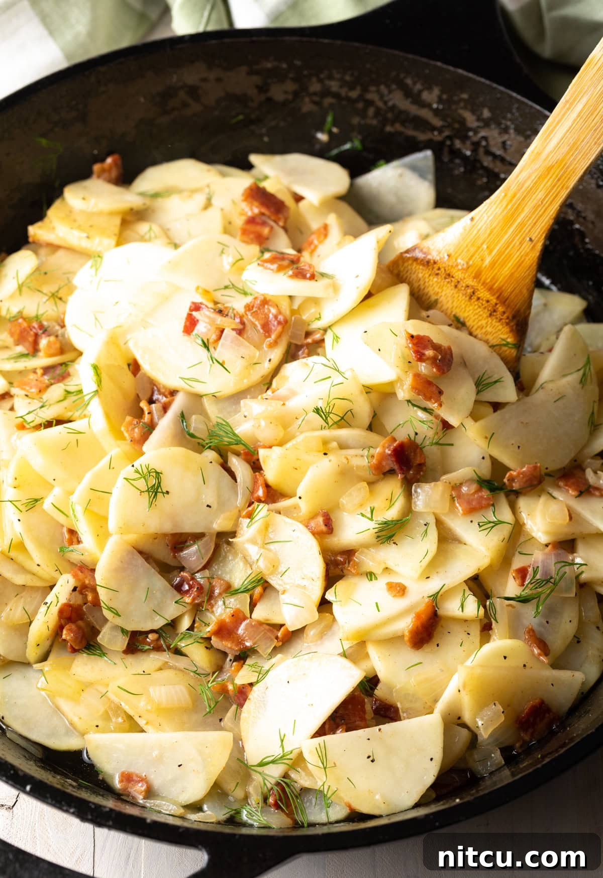 Emerald Spud Pie 5 Potatoes, bacon, onions, and fresh dill gently cooking together in a large skillet, coated in savory bacon fat.