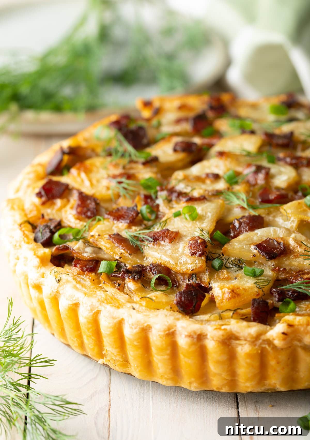 Emerald Spud Pie 8 A delicious side view of the baked Irish potato tart, revealing its layers of potatoes and golden crust.
