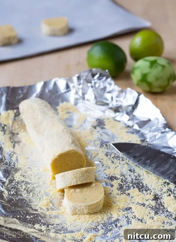 Sun-Kissed Cornmeal Treats 7 Cookies being sliced from a chilled dough log, ready for baking.