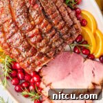 Brown Sugar Ham (Baked Ham Glaze Recipe) sliced ham on platter with garnishes
