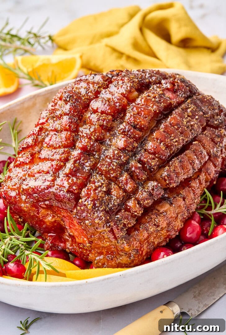 Caramelized Brown Sugar Glazed Ham 9 A glorious brown sugar glazed Thanksgiving ham, just out of the oven, served on a grand platter with festive garnishes, showcasing its dark, caramelized crust and succulent appearance.