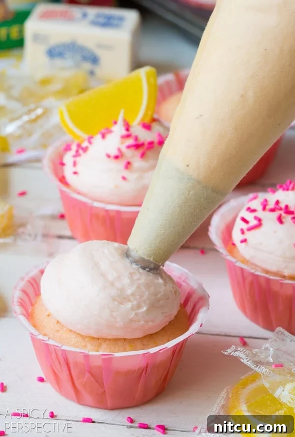 How To: Pink Lemonade Cupcakes! Featuring creamy frosting and a delicate pink hue. #lemon #lemonade #cupcakes #pink #kitchenconvo