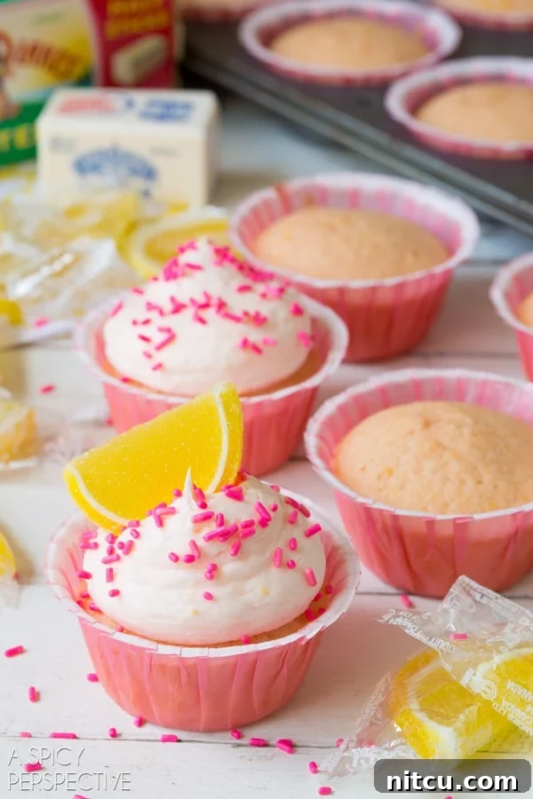 Pretty Pink Lemonade Cupcakes, a vibrant summer dessert. #lemon #lemonade #cupcakes #pink #kitchenconvo