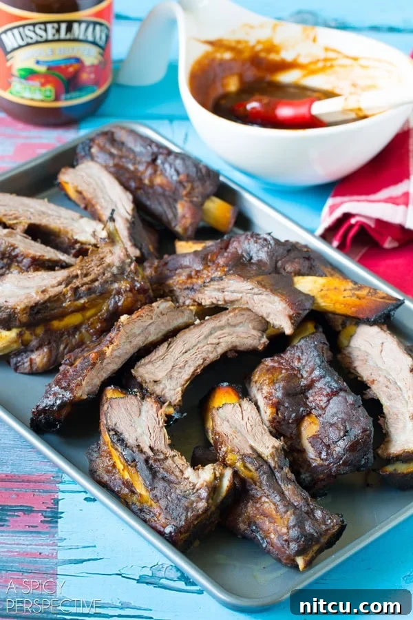 Sticky Soy-Glazed Asian Short Ribs 3 Cooked Asian beef ribs on a tray.