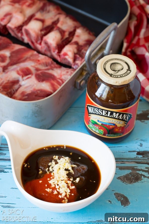 Sticky Soy-Glazed Asian Short Ribs 4 Closeup view of ramekin filled with Musselman's apple butter, garlic, Sriracha, soy sauce and fish sauce.
