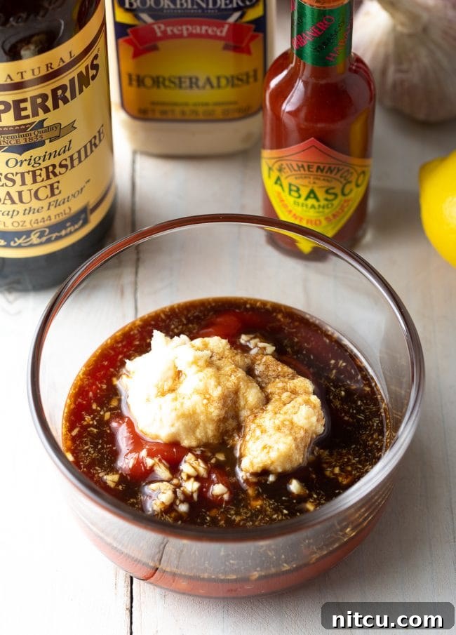 All the essential ingredients for cocktail sauce gathered in a bowl, showcasing the fresh and simple components.