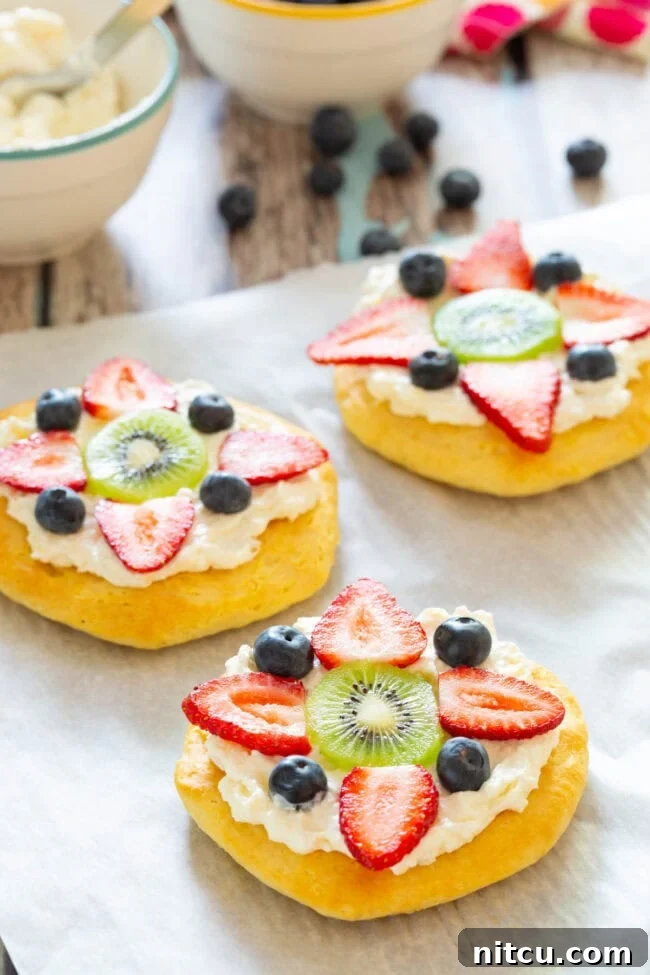 Sweet Start Fruit Pizza 2 Close-up shot of a beautiful Fruit Pizza for Breakfast, garnished with fresh berries and kiwi slices.