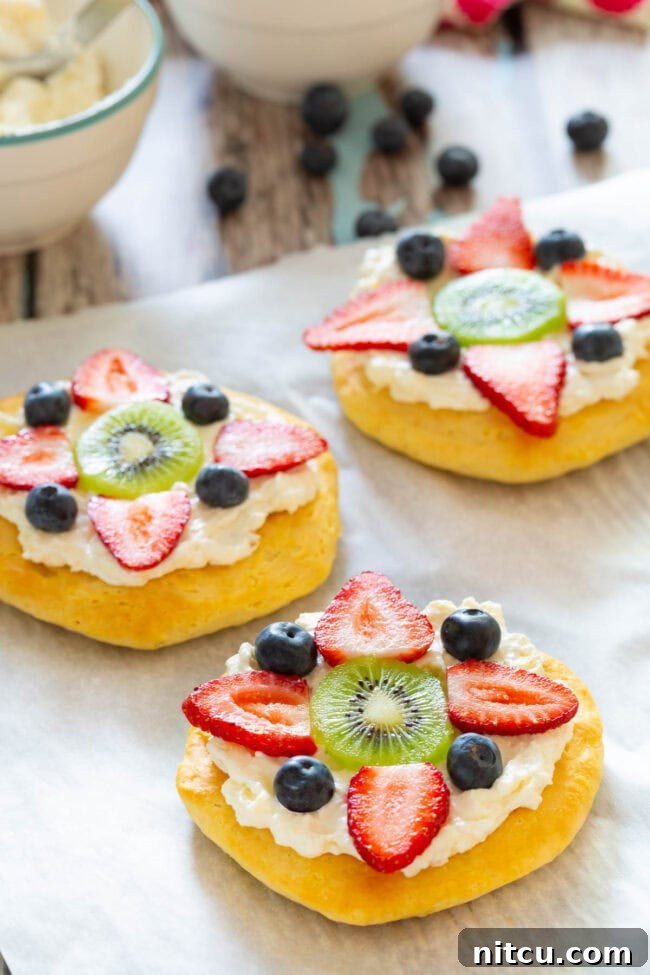 Sweet Start Fruit Pizza 7 Close-up shot of a breakfast fruit pizza on a baking sheet, topped with colorful berries, ready to serve.