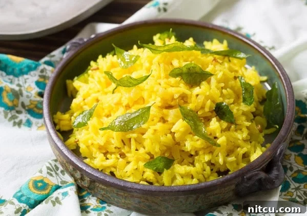 Close-up shot of Indian Rice in a elegant bowl, beautifully garnished with crispy, fried curry leaves.