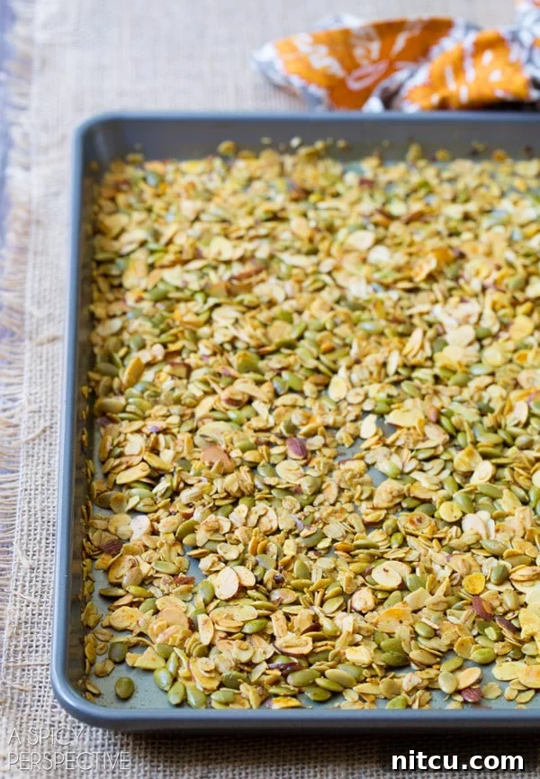 Golden Roasted Root Medley 5 Homemade granola spread out on a baking sheet.