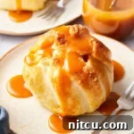 Flaky Apple Pastry Pockets 14 Simple baked apple recipe with puff pastry on a plate, caramel sauce over the top