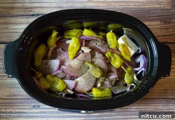 Perfect Slow Cooker Italian Beef 4 Close-up of ingredients for Slow Cooker Italian Beef Recipe including beef, onions, and pepperoncinis