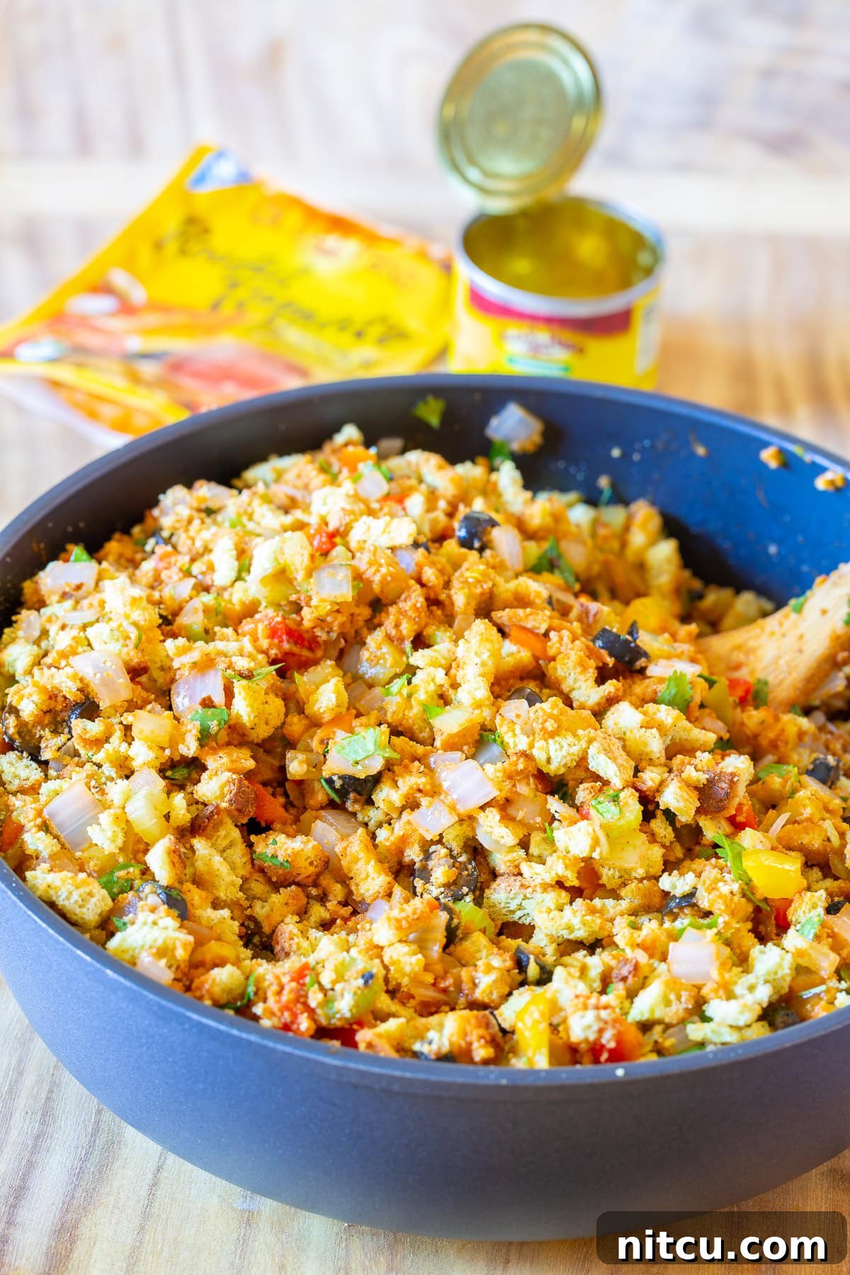 Tex-Mex Stuffing Ingredients Southern cornbread dressing ingredients with green chiles arranged around a skillet, ready for preparation
