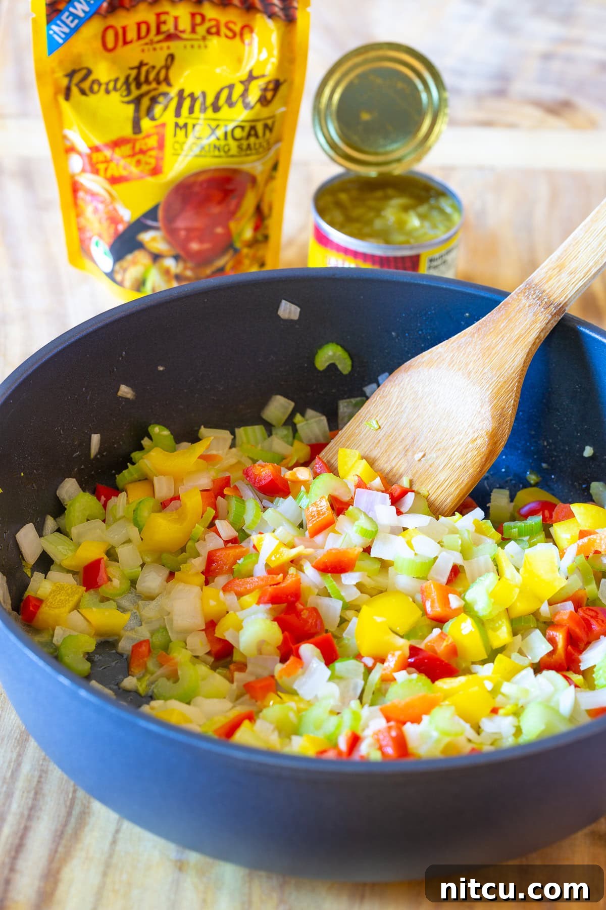 Sautéed Stuffing Vegetables Cornbread dressing with vibrant, sautéed vegetables for stuffing in a large skillet