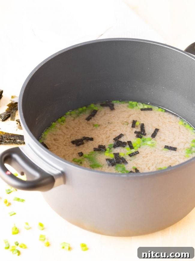 mushroom-miso A whole pot filled with fresh, homemade miso soup, ready to be served.