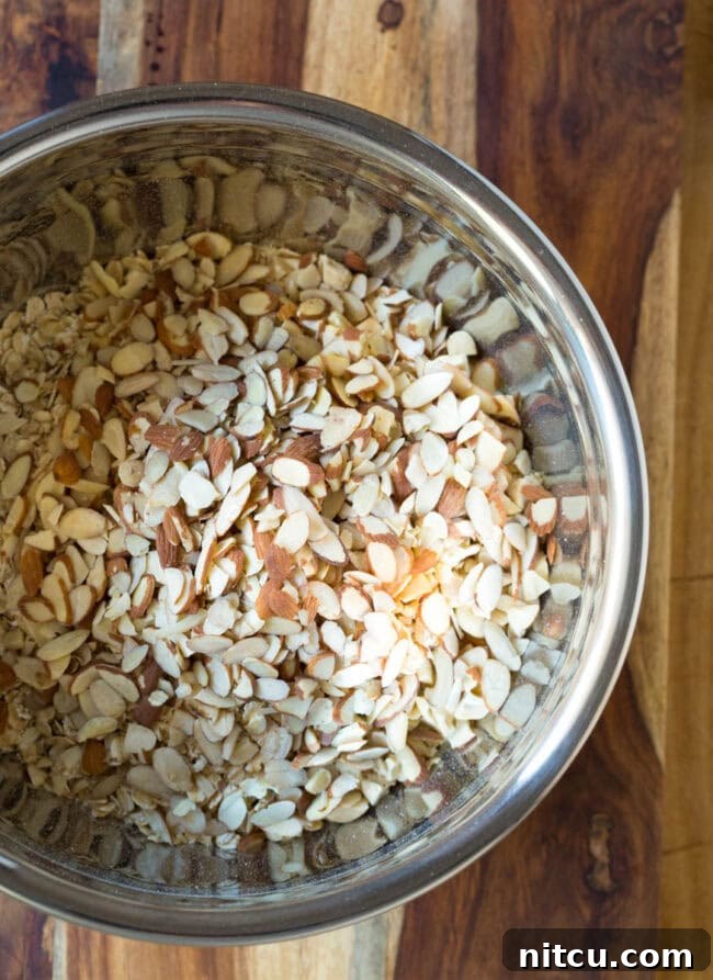 Granola and nuts in a mixing bowl.