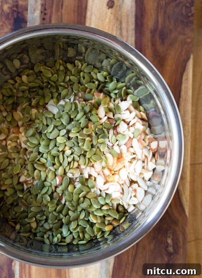 Seeds added to nut mixture in mixing bowl.