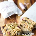 Homemade granola bars on a wooden cutting board.