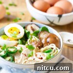 A small, tempting image of Slow Cooker Chicken Ramen Noodles, garnished and ready to eat.