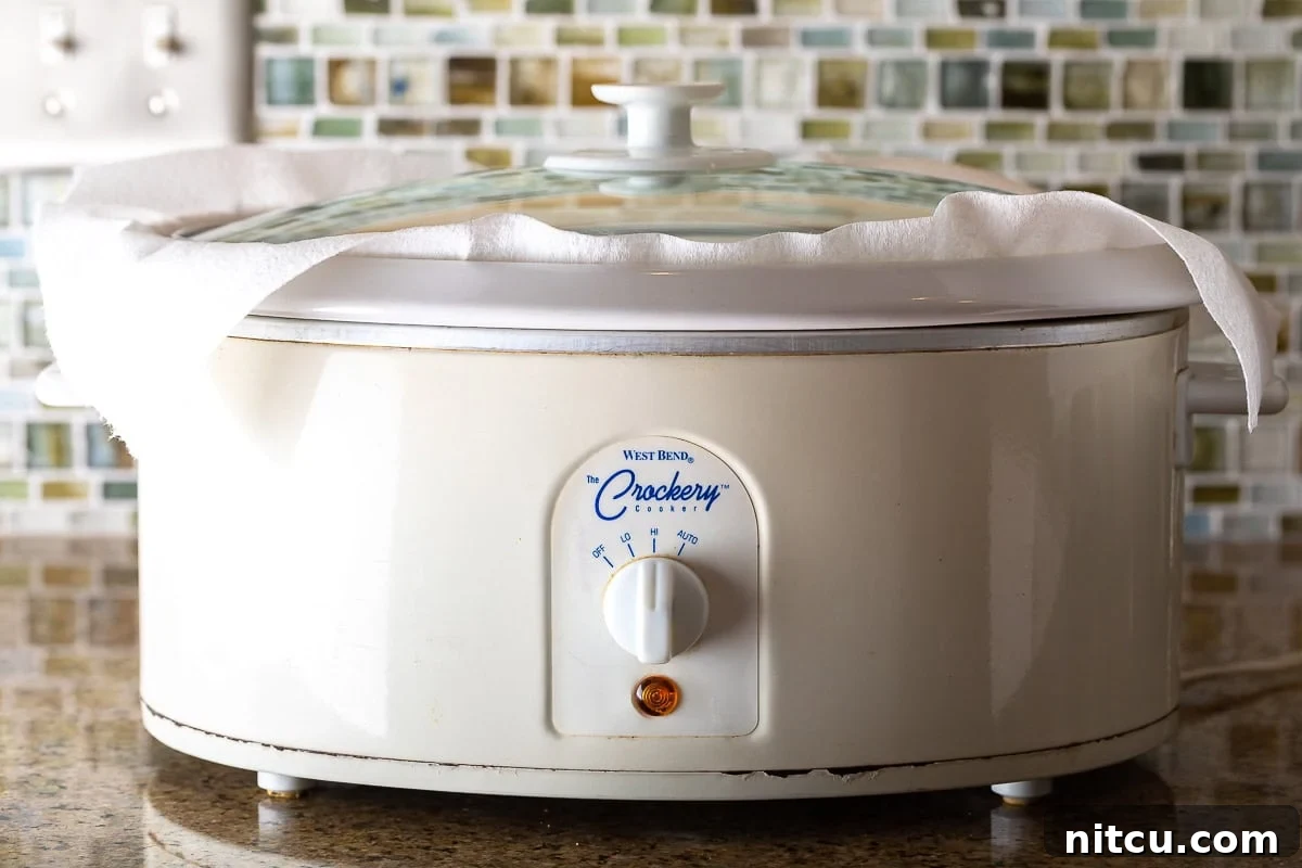 Side shot of a white crock pot. 