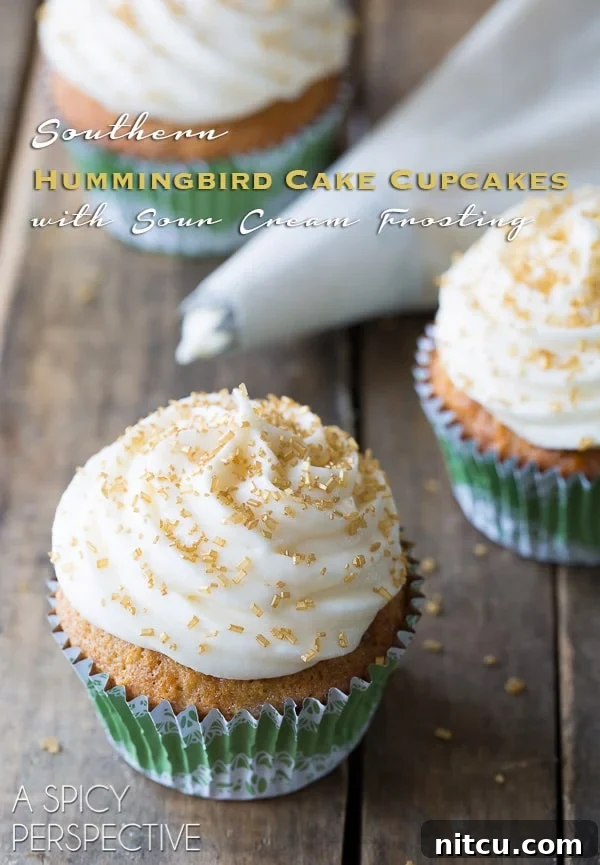 Hummingbird Cake transformed into delightful cupcakes with sour cream frosting for spring and Southern charm. Hummingbird Cupcakes, a Southern classic dessert, beautifully decorated and ready to be enjoyed.